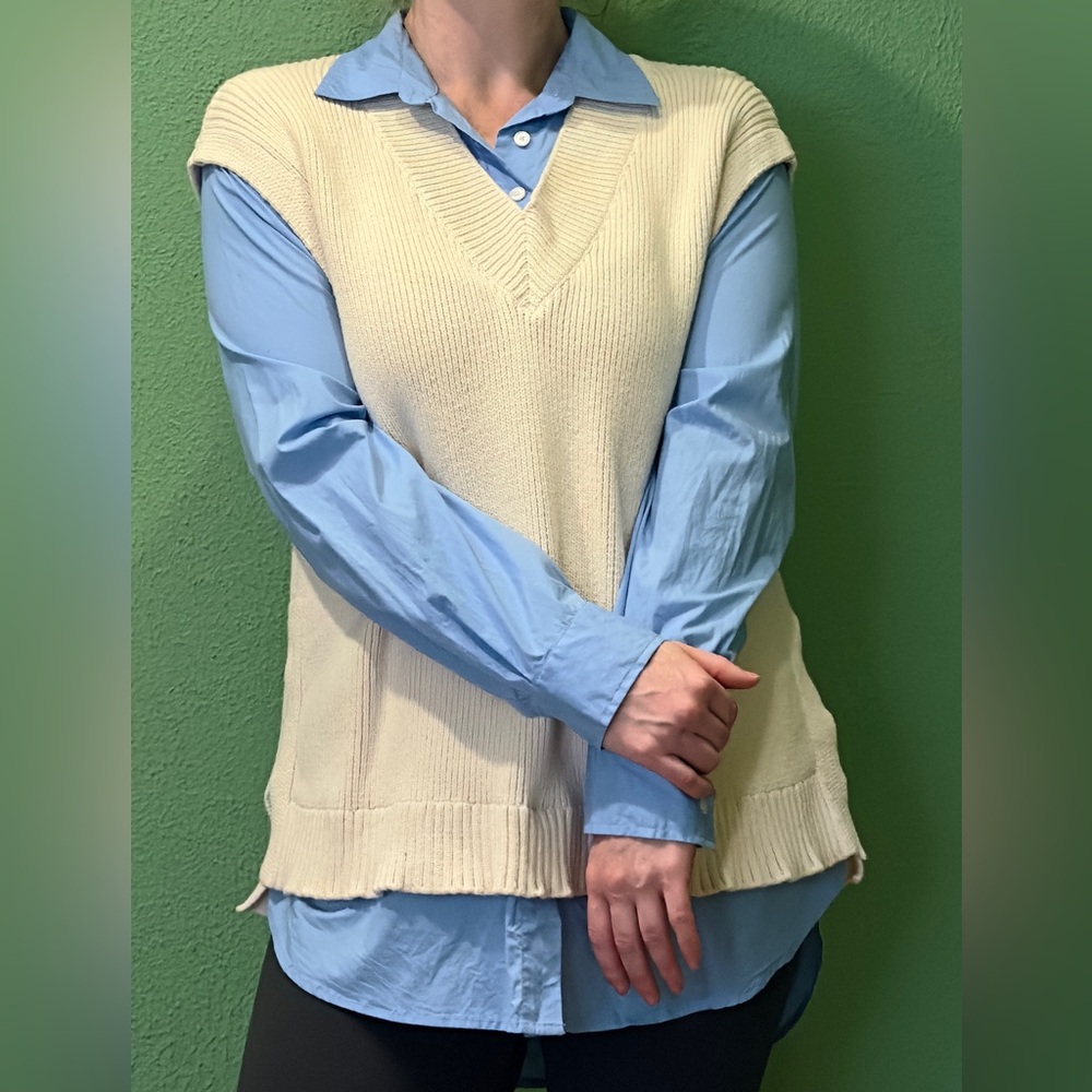 Chic sweater vest layered over the shirt